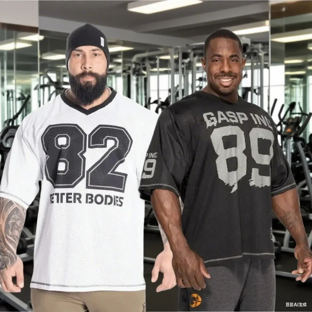 Men's short sleeved quick drying polyester sports t-shirts in black and white worn at gym